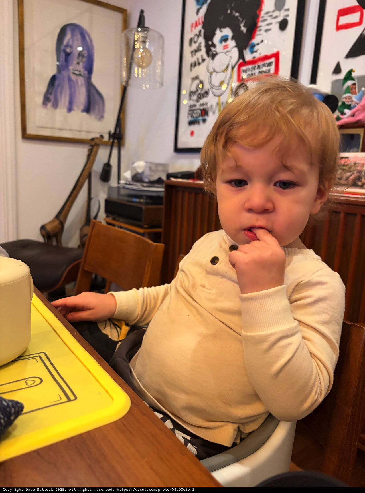 Toddler's Thoughtful Moment in Artistic Living Space