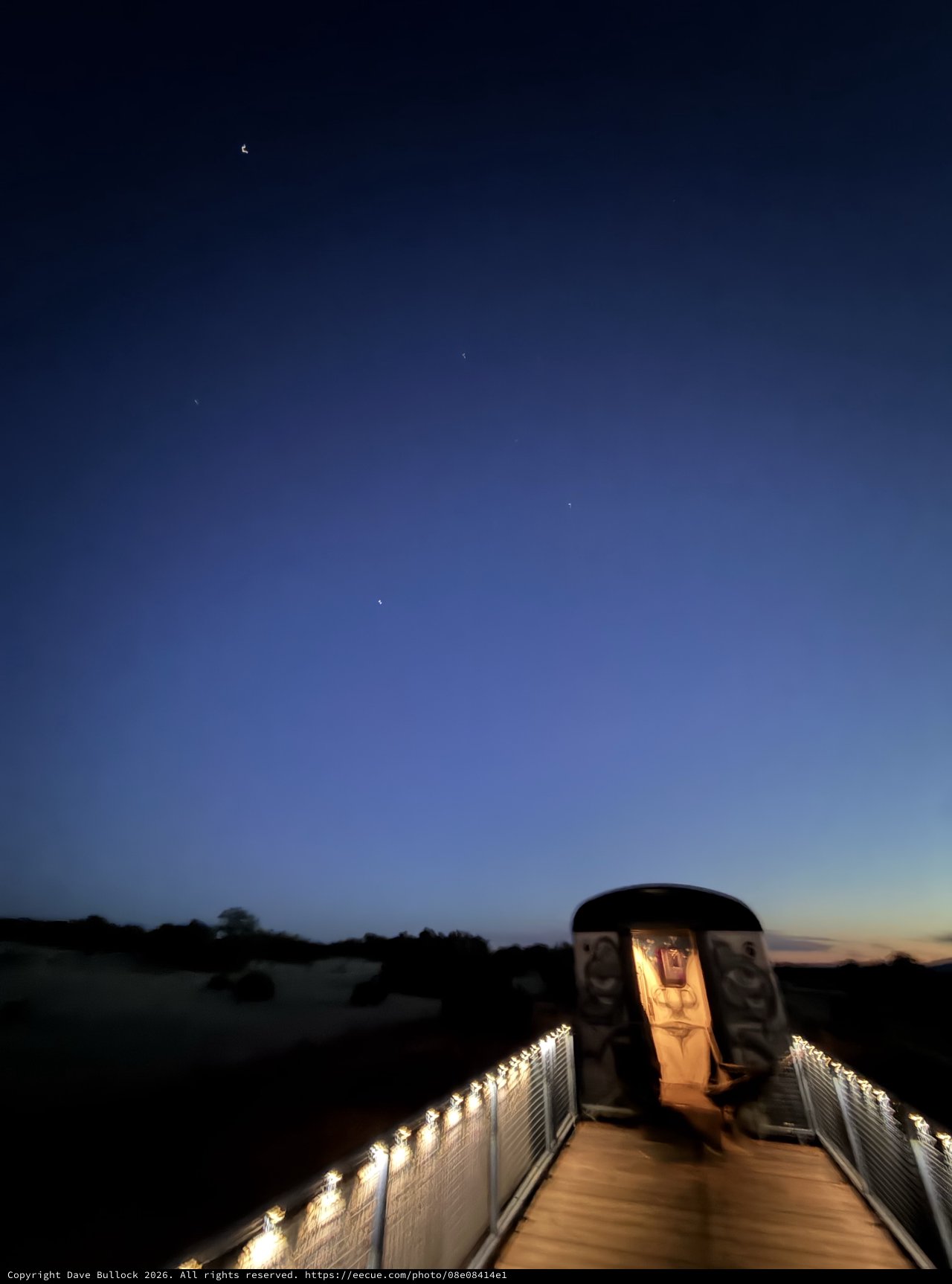 Twilight Memorial: Illuminated Walkway Under Evening Stars