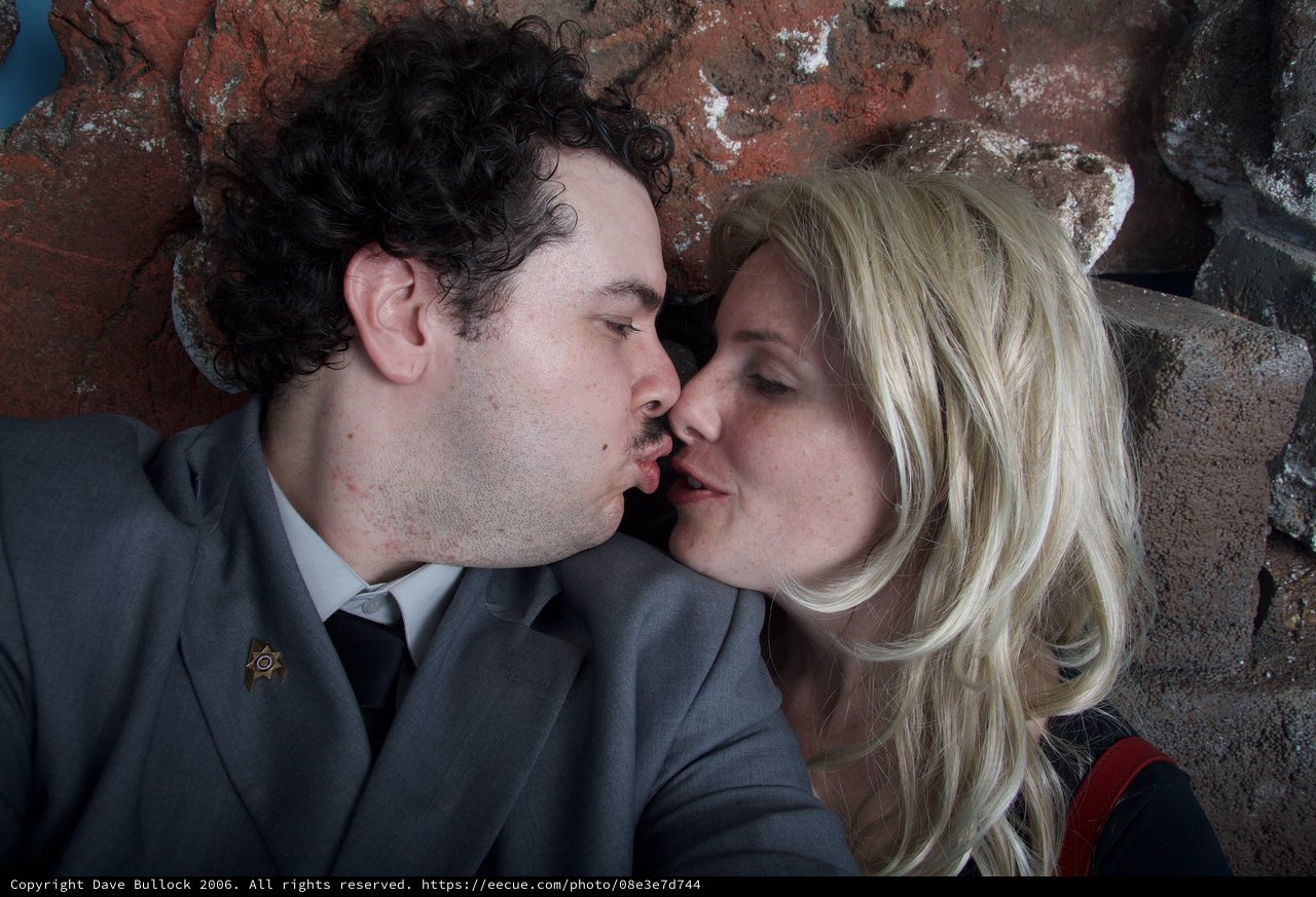 Romantic Halloween Kiss Against Rustic Brick Wall