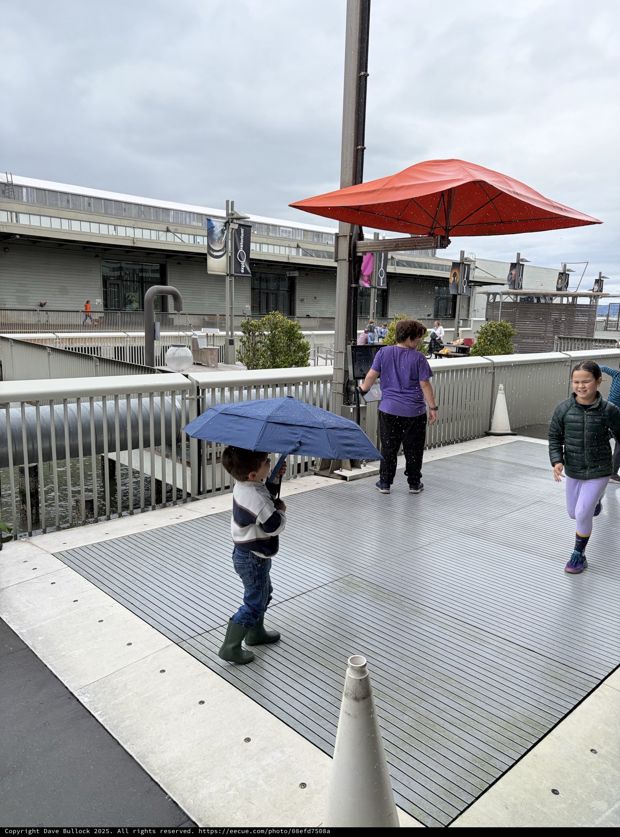 Children Playing on Rainy Day Rooftop Plaza