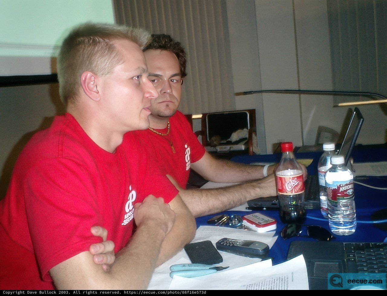 Two Men Work and Drink at Desk