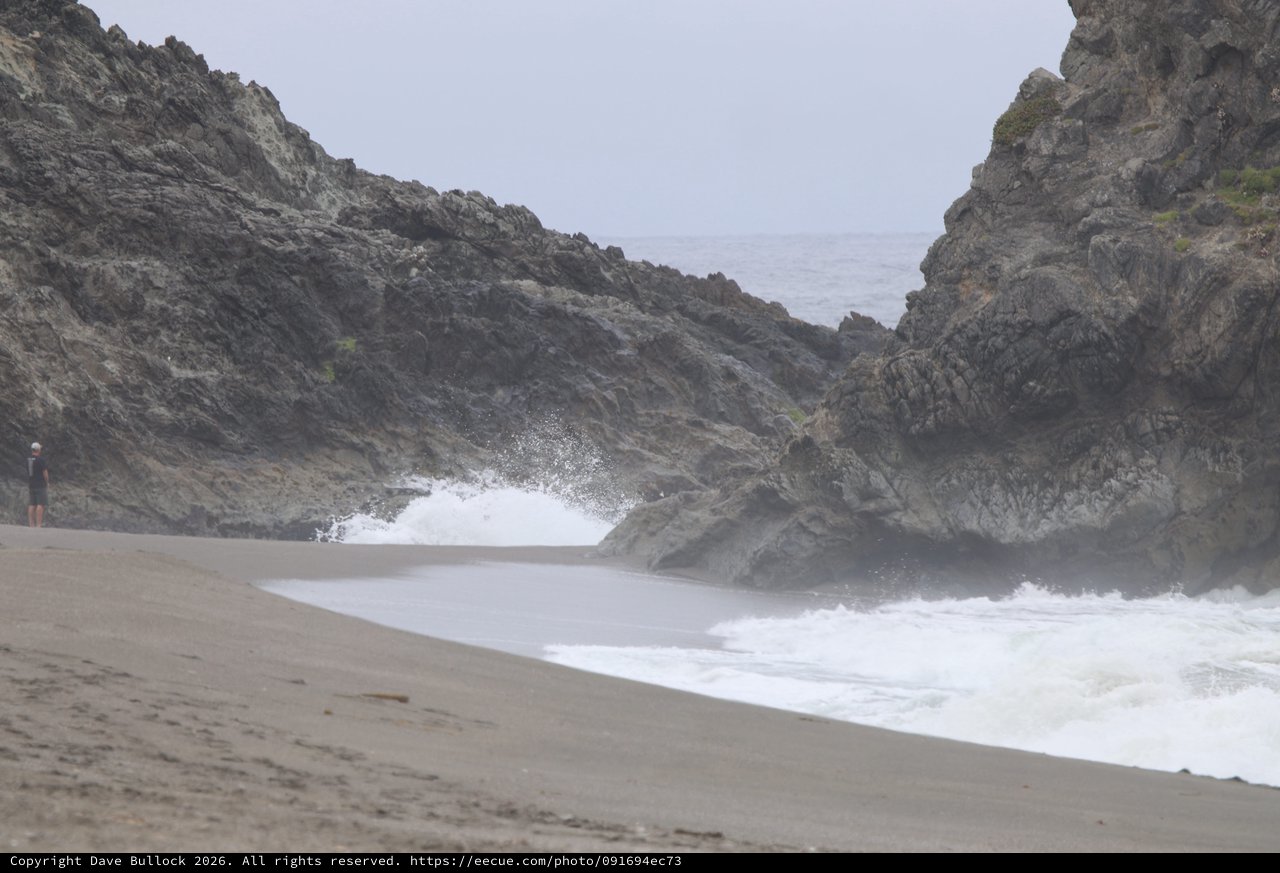 Crashing Waves Through Rocky Coastal Cliffs