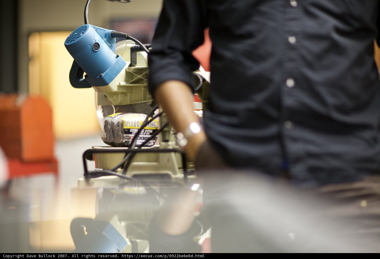Man Standing in Front of Industrial Machine