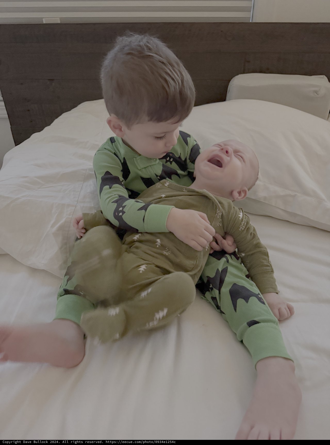 Big Brother Meeting Baby Sibling on Bed