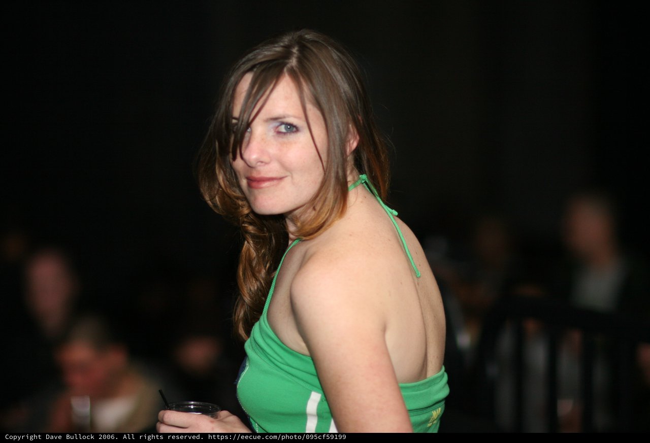 Woman in Green Halter Top at Evening Social Event