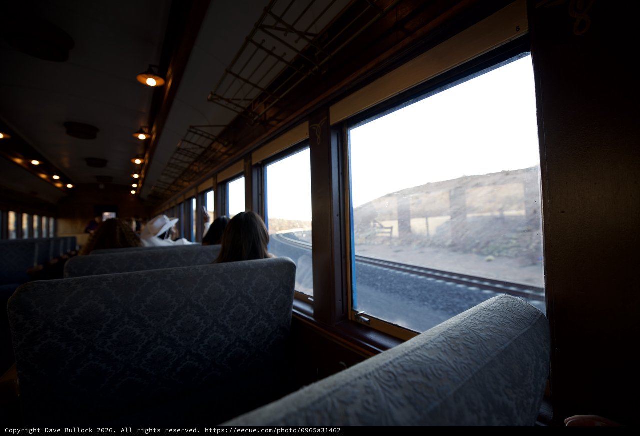 Contemplative Train Journey Through Desert Landscape