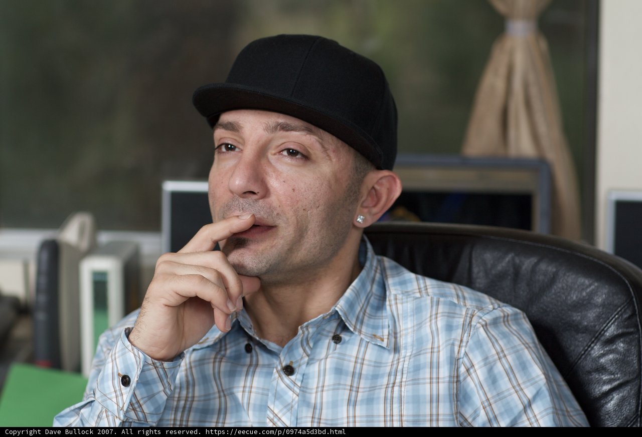Contemplative Man in Fedora Hat at His Desk