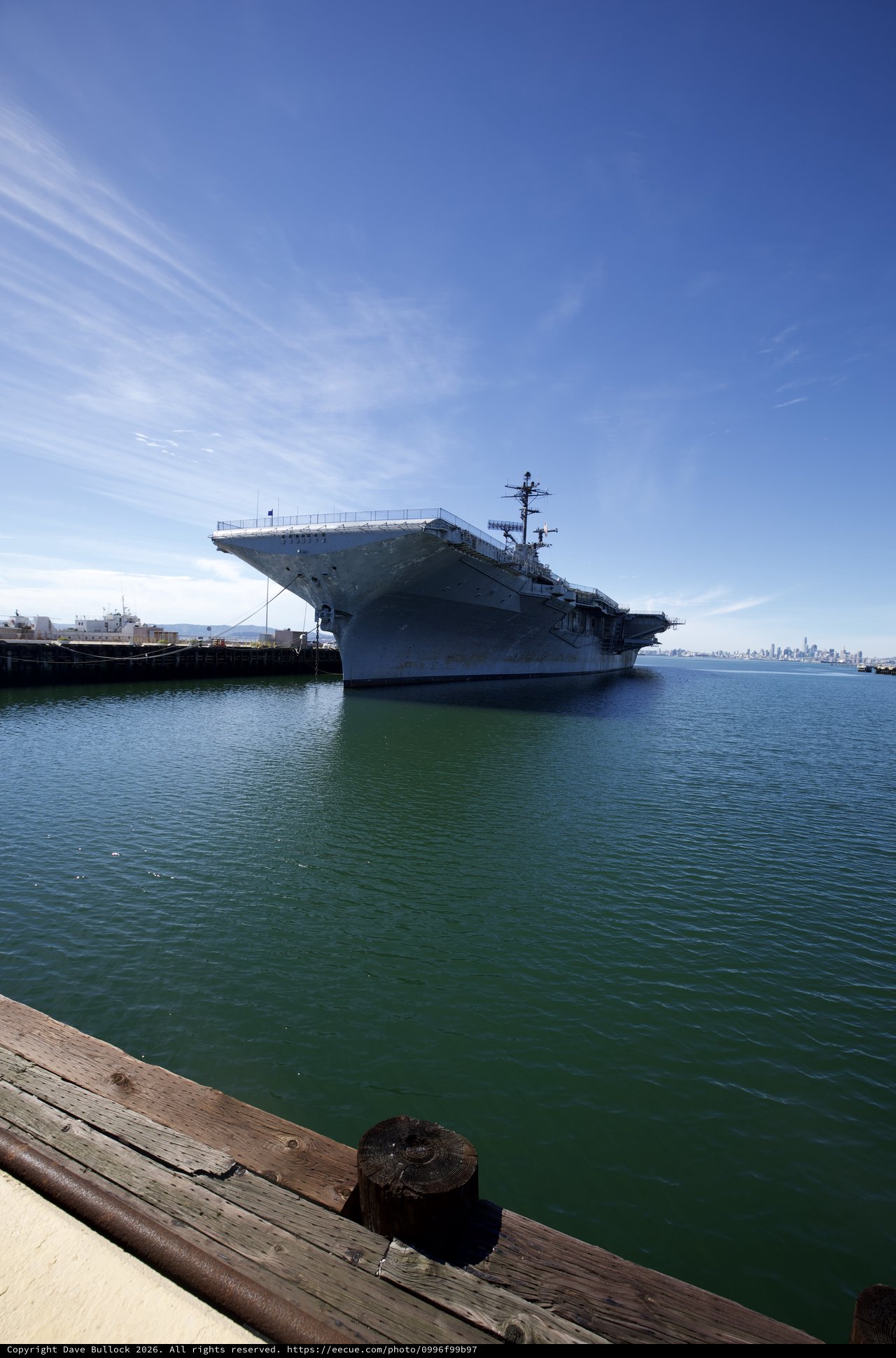 Historic Aircraft Carrier Docked in Tranquil Harbor