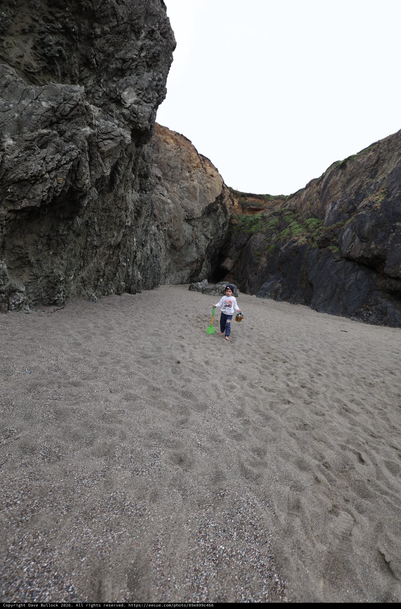 Young Explorer Roaming a Secluded Rocky Cove