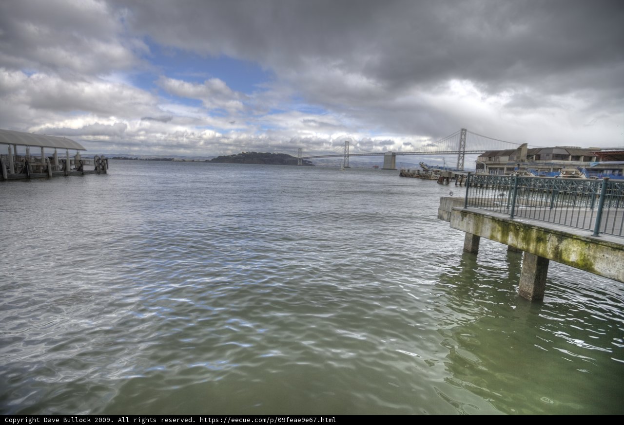Serene Waterfront Pier with Breathtaking Bridge View