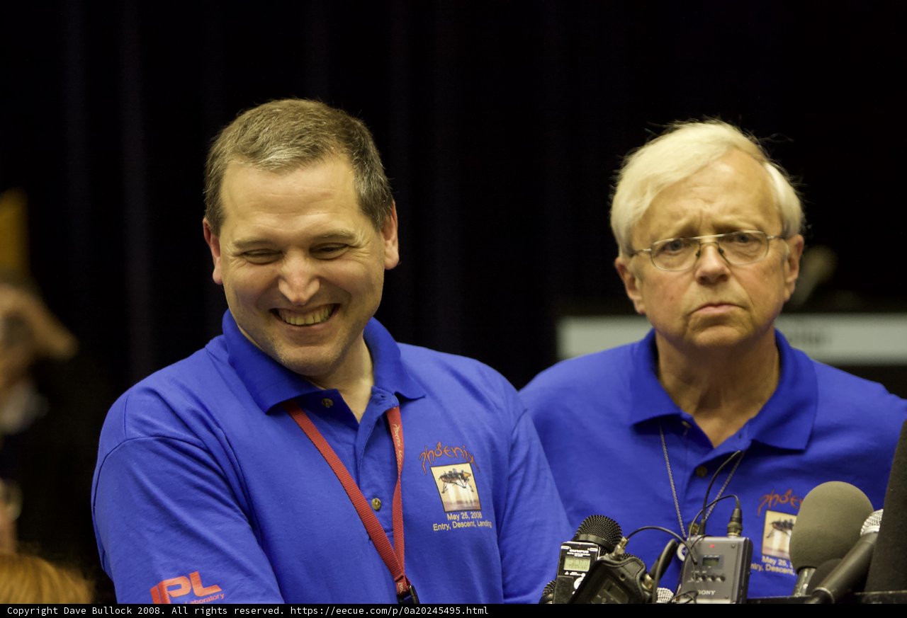 Blue-Shirted Men Discuss at Phoenix Press Conference