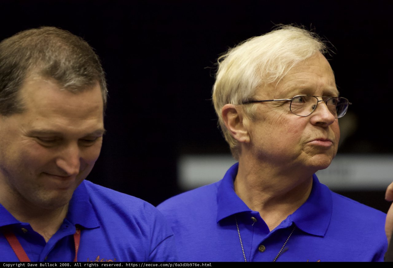 Two Men in Blue Shirts and Glasses