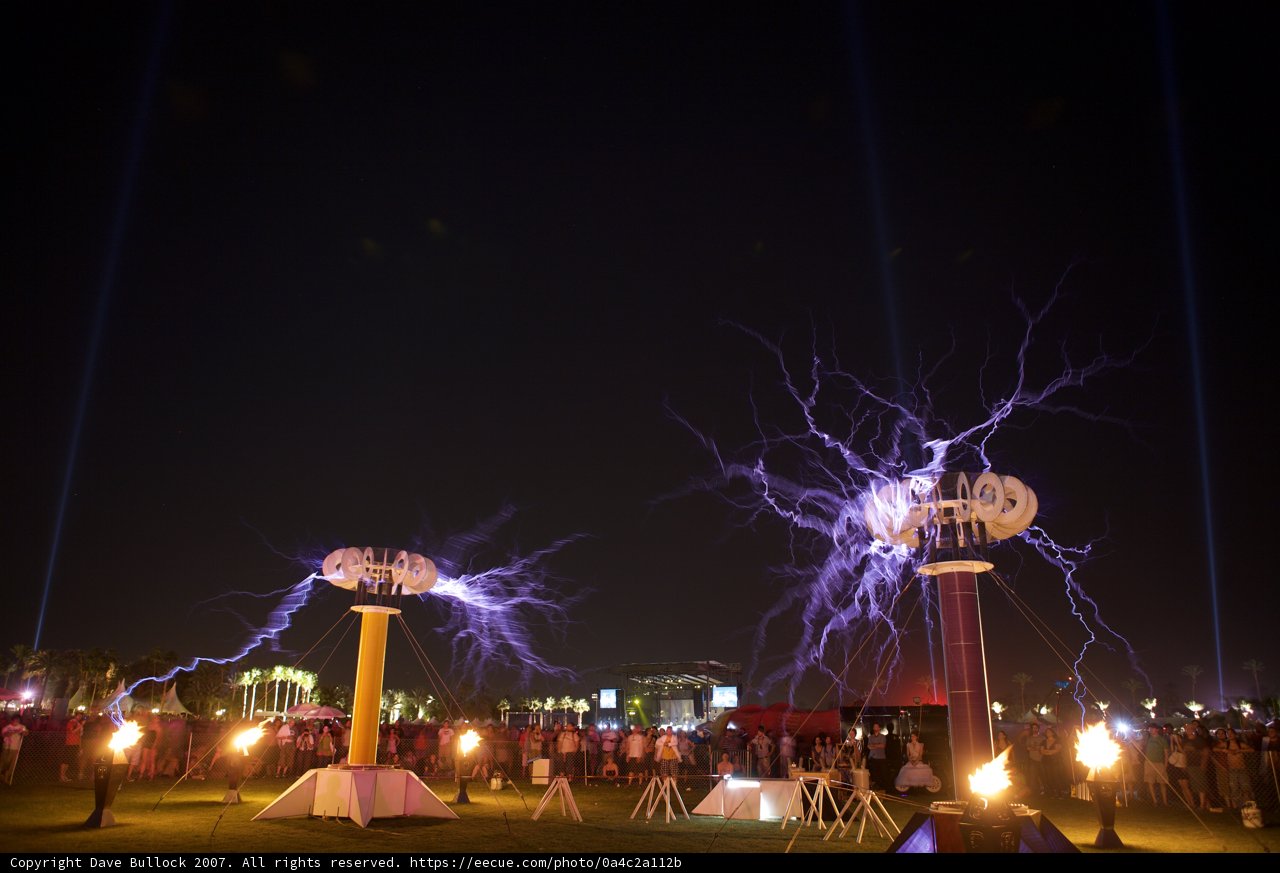 Electric poles with lightning in night sky