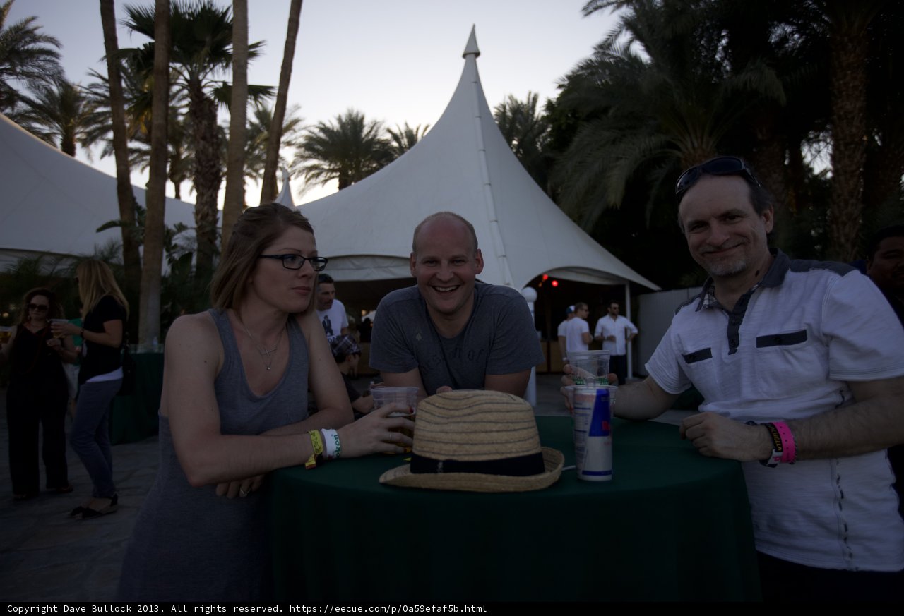 Outdoor Dining with Friends Caption: Michael R enjoys an afternoon meal with two friends under the shade of a palm tree at Coachella Weekend 2.