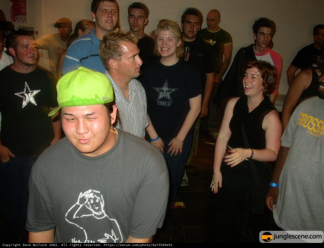 Green Hat Man Draws a Crowd at the Club