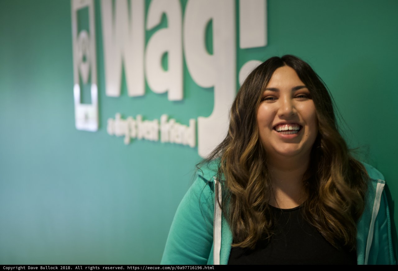 Happy Woman Poses with WAG Logo