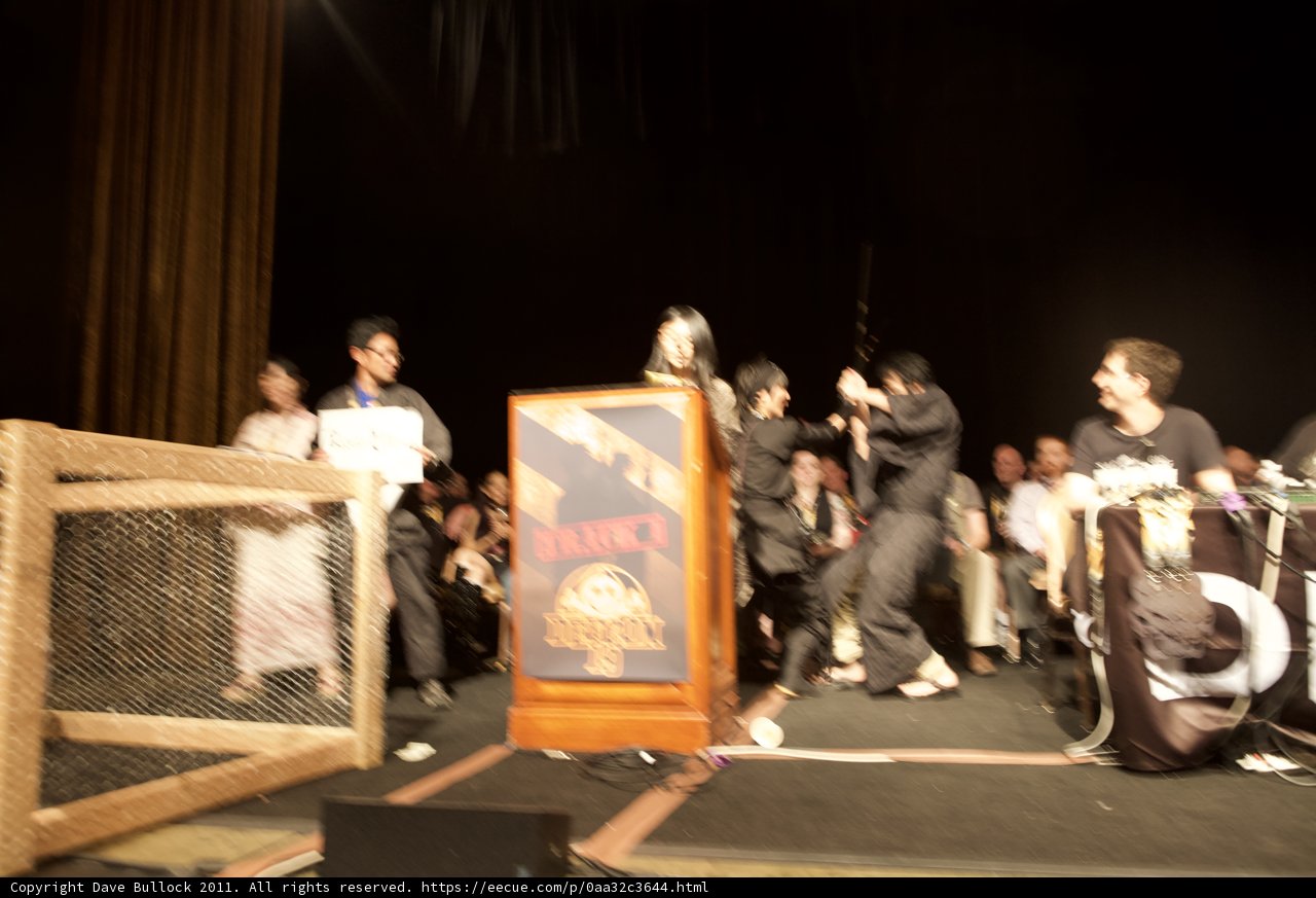 Group of Performers Stand Around Podium