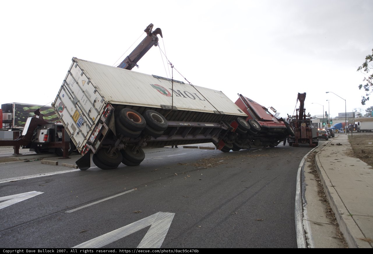 Truck Lifted by Crane on Tarmac Road