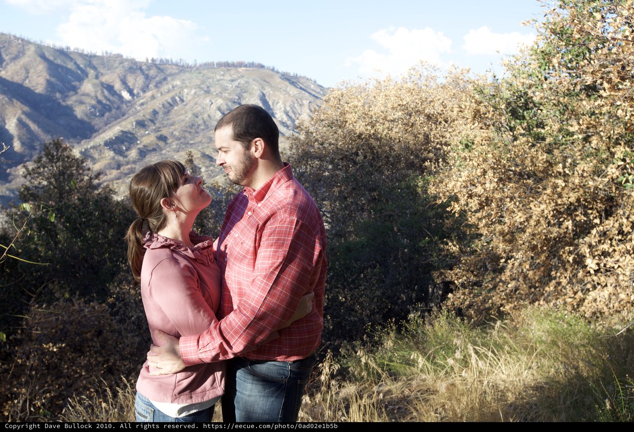 Couple Embracing Amid Autumn Mountain Wilderness
