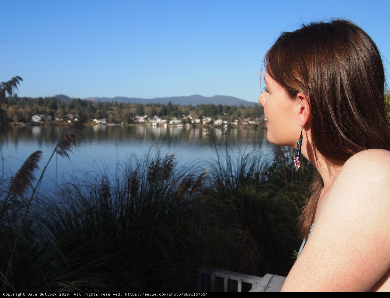 Woman Gazes Peacefully Across a Serene Lake