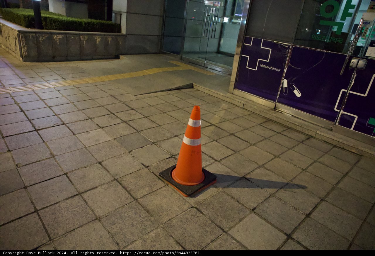 Urban Solitude: A Traffic Cone's Watch