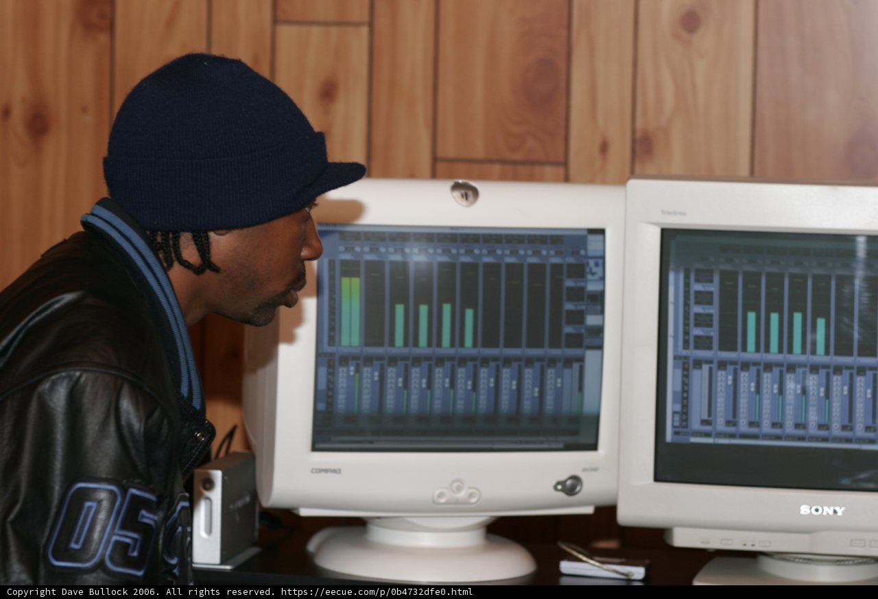 Man in Black Jacket Typing on Computer Monitors