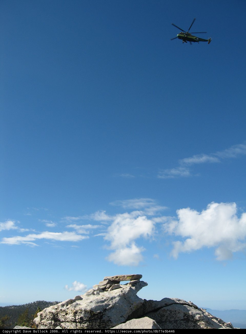 Helicopter soaring over rocky terrain