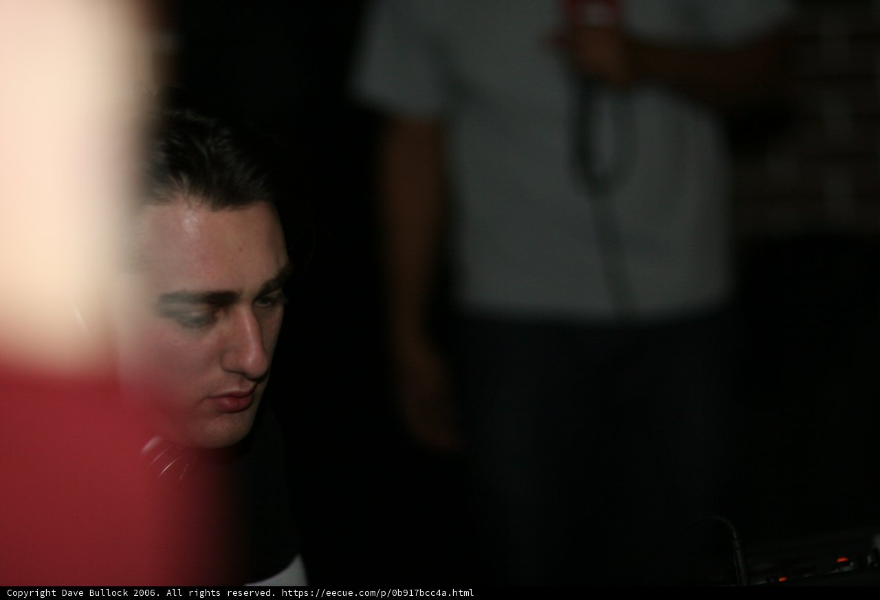 Man fervently examines electrical device at club