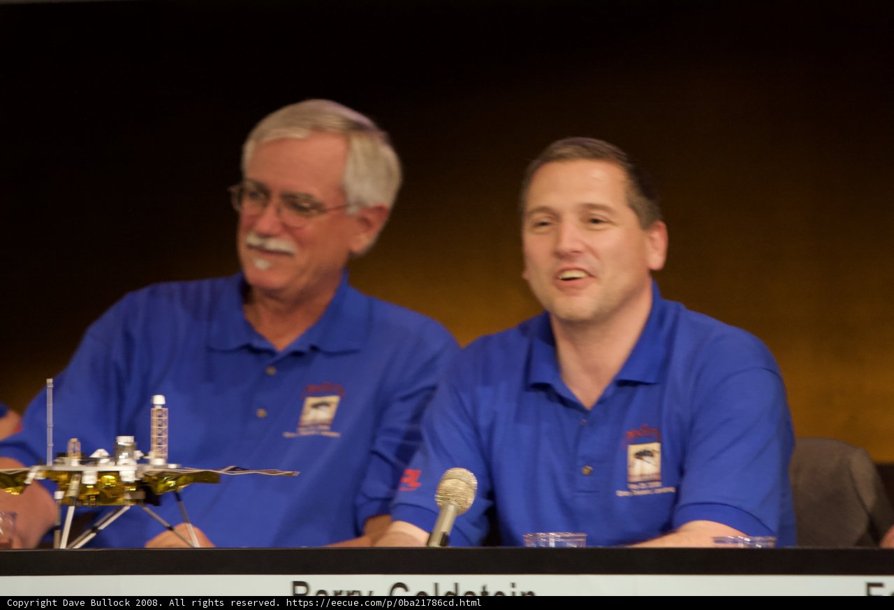 Press Conference Featuring Two Men in Blue Shirts at Phoenix Landing