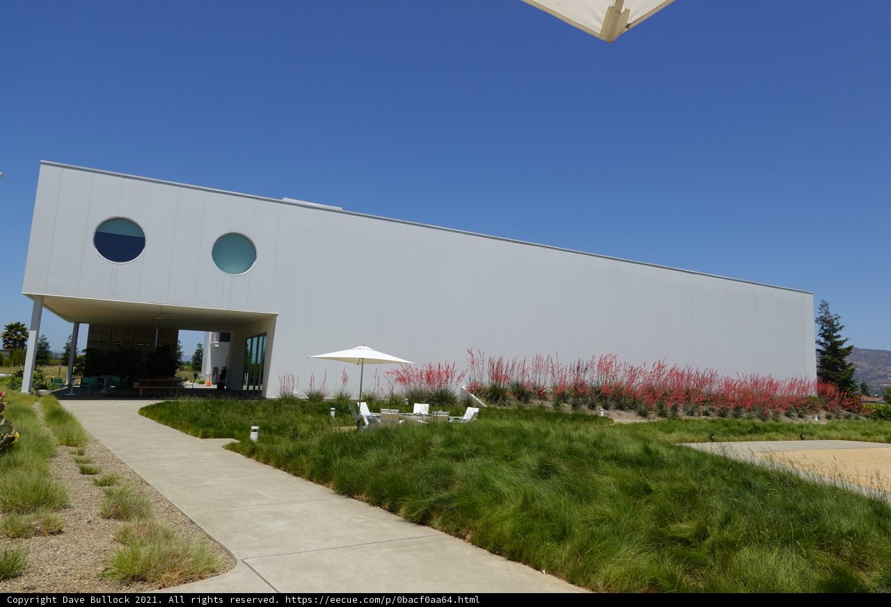 White Office Building with Grassy Front Lawn and Fence