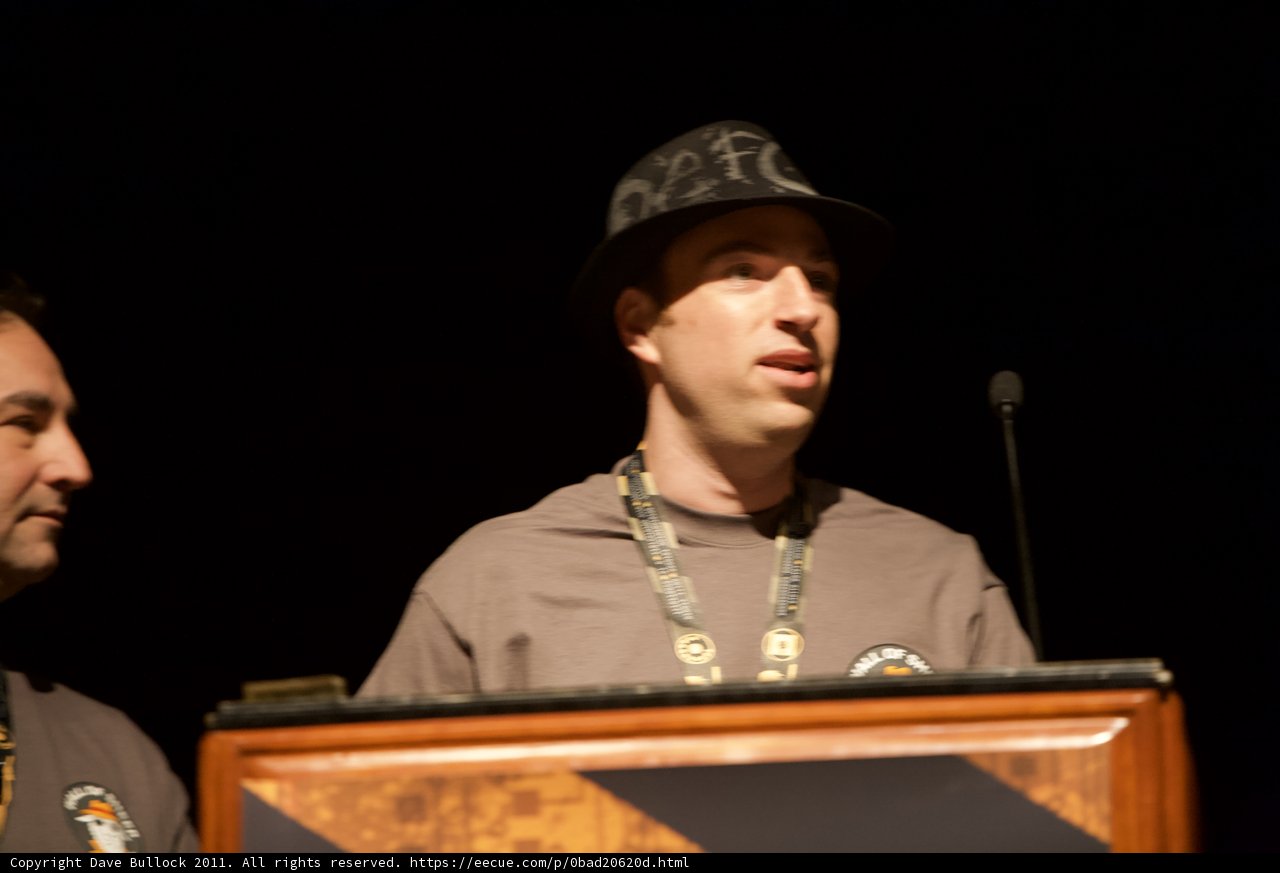 Two Men Speak at Podium
