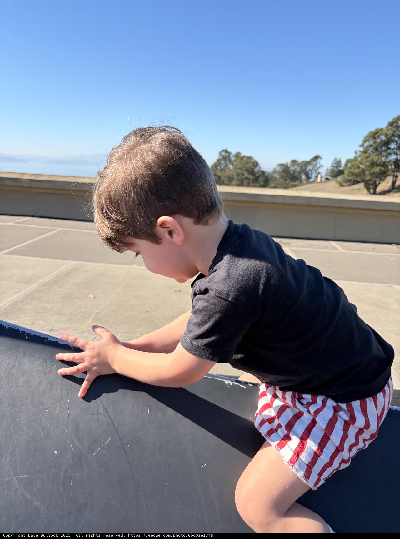 Young Boy Playing on Rooftop Parking Structure