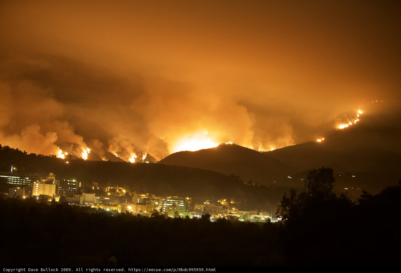 Flames Engulf Hills Above Cityscape