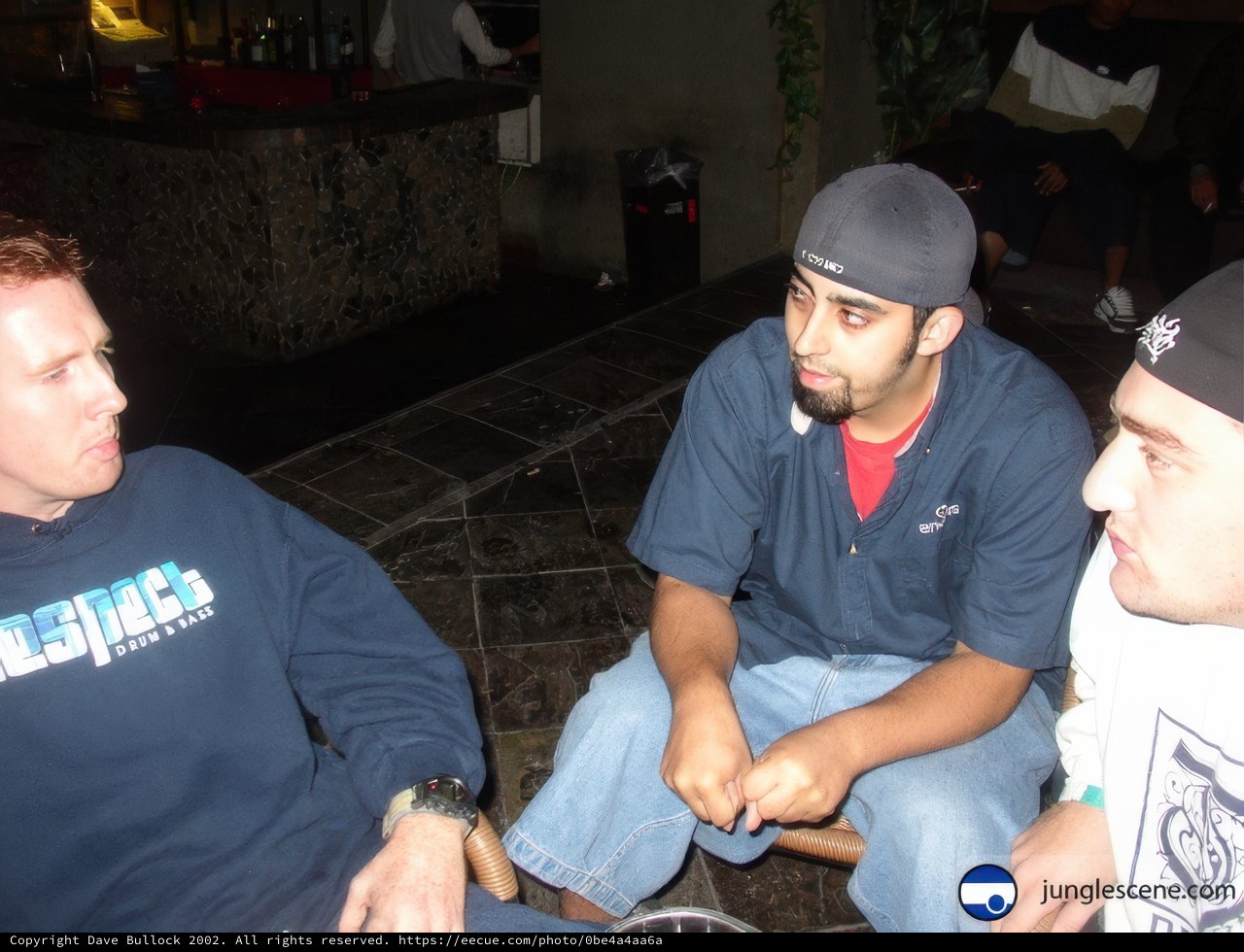 Three Men Enjoying a Chat at the Local Hangout