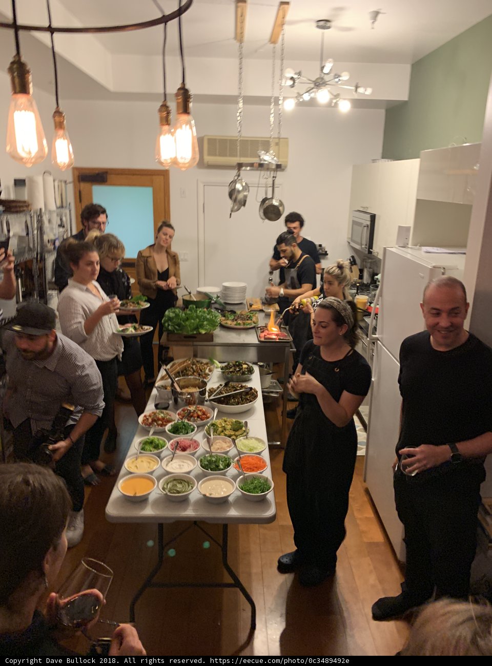 A Gathering of 13 People at a Restaurant Buffet