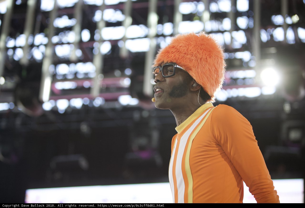 Orange-clad Man Rocks Out on Stage