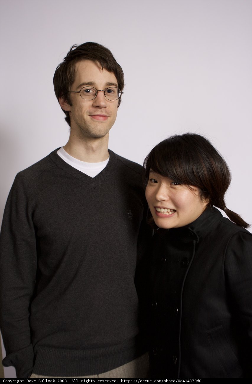 Smiling Couple in Jackets and Glasses