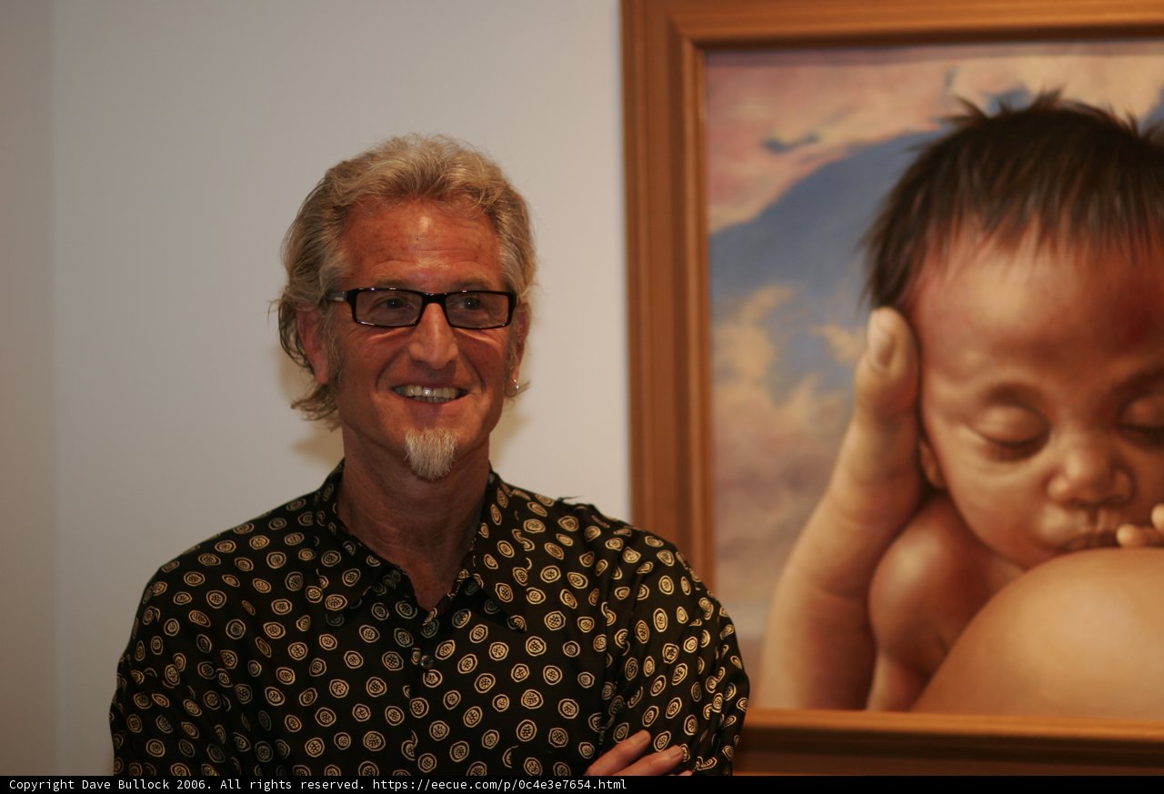 Man Reflecting on Art with Glasses