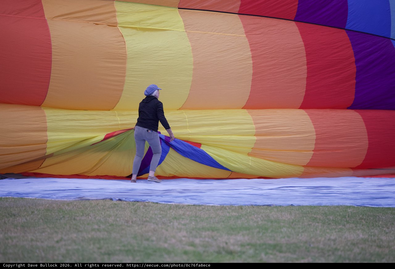 Ground Crew Prepares Rainbow Hot Air Balloon for Launch