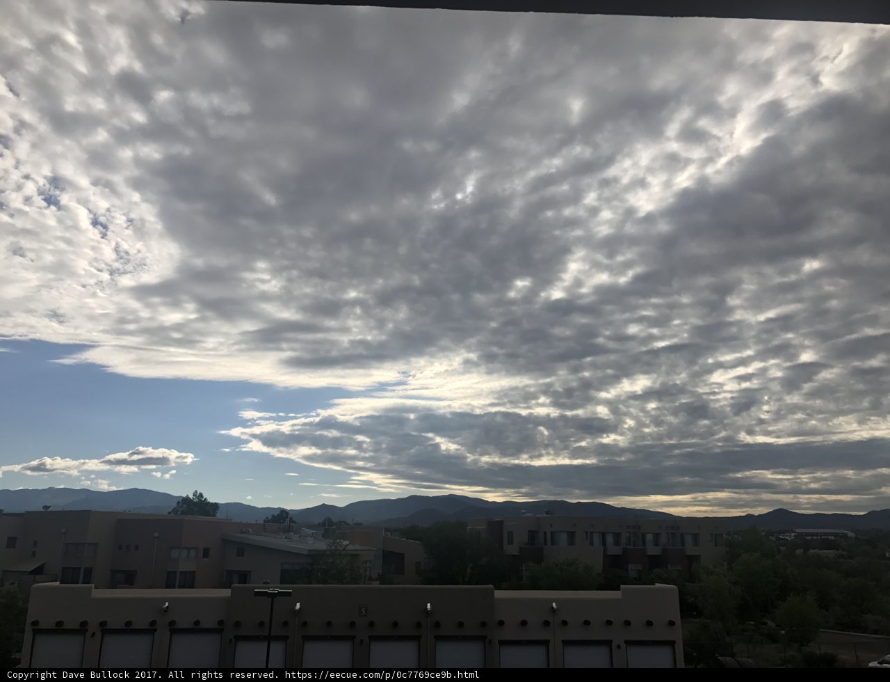 A Breathtaking View of Santa Fe's Skyscrapers with a Blue Sky and Cumulus Clouds