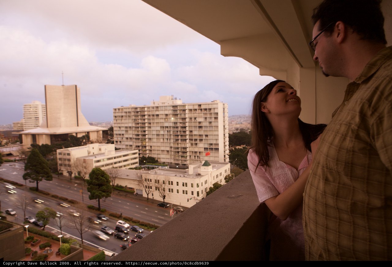 Couple Gazing From Hotel Balcony at Dusk