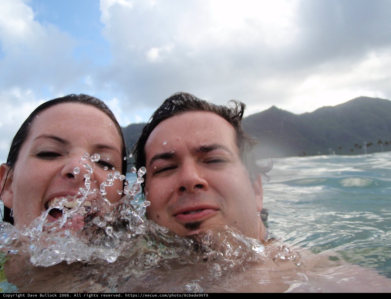 Couple Laughing in Hawaiian Ocean Waves
