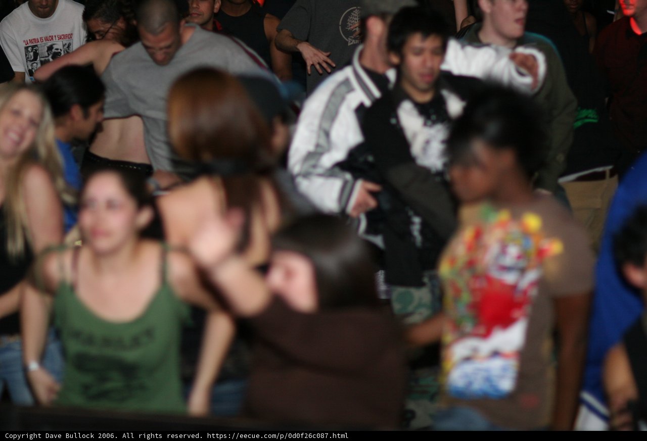 Dance the Night Away Caption: Seb la Frite and a crowd of 15 people enjoying a night of dancing at the 2006 APC office and Vday 1 event, showcasing their urban style and T-shirts.