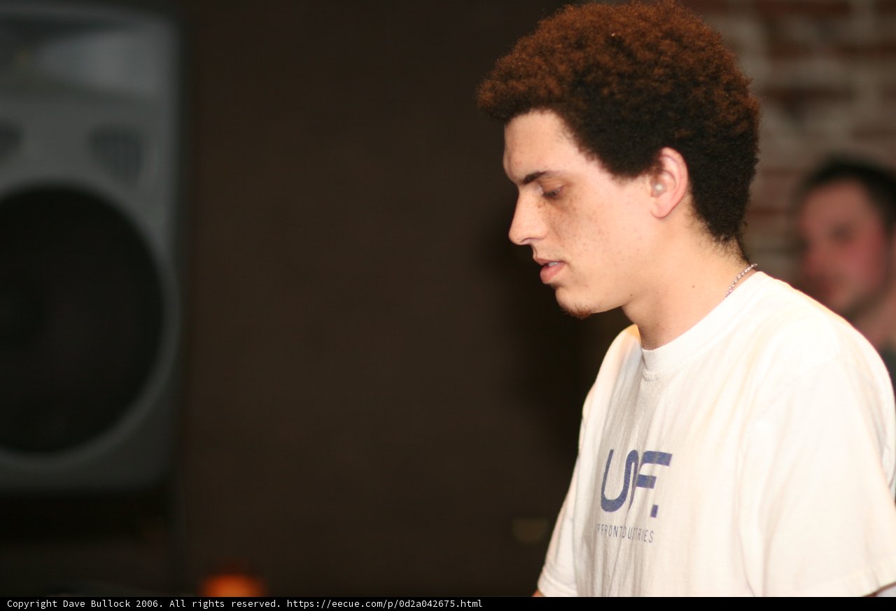 Curly-haired Man Takes Over the Mic at Breakage Concert