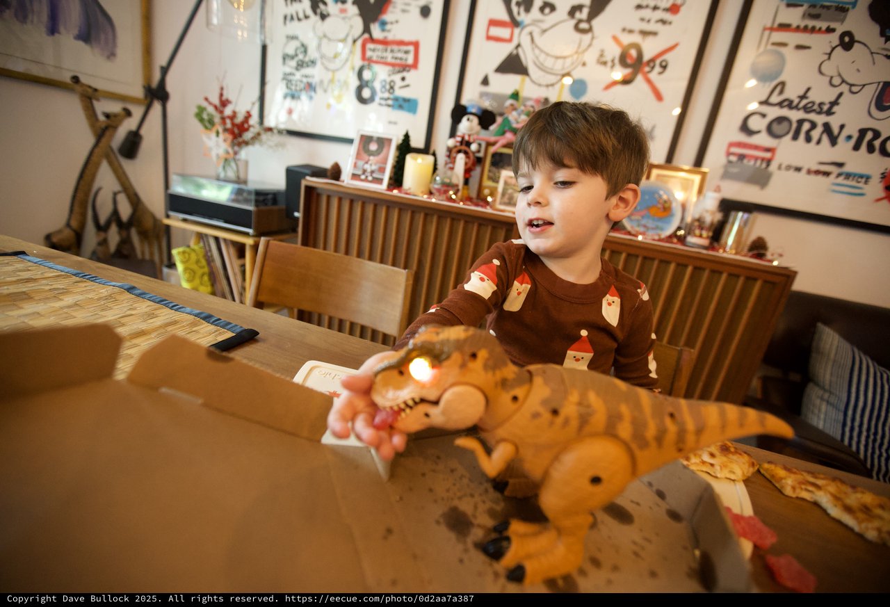 Child Playing with Stuffed Tiger Toy at Christmas Dinner Table