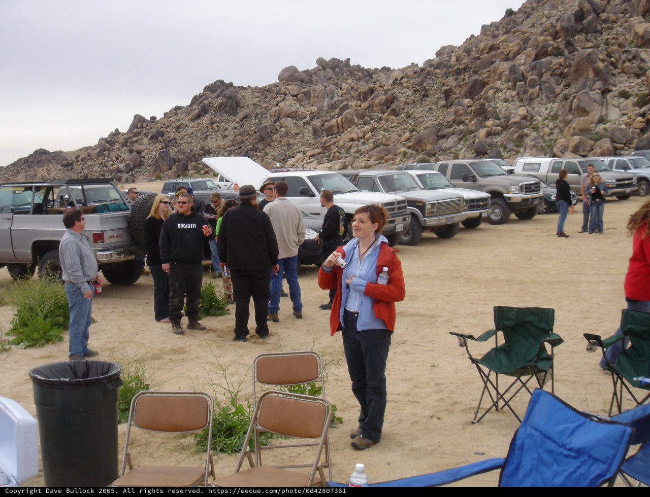 Desert Gathering Among Rocky Boulders with Off-Road Trucks
