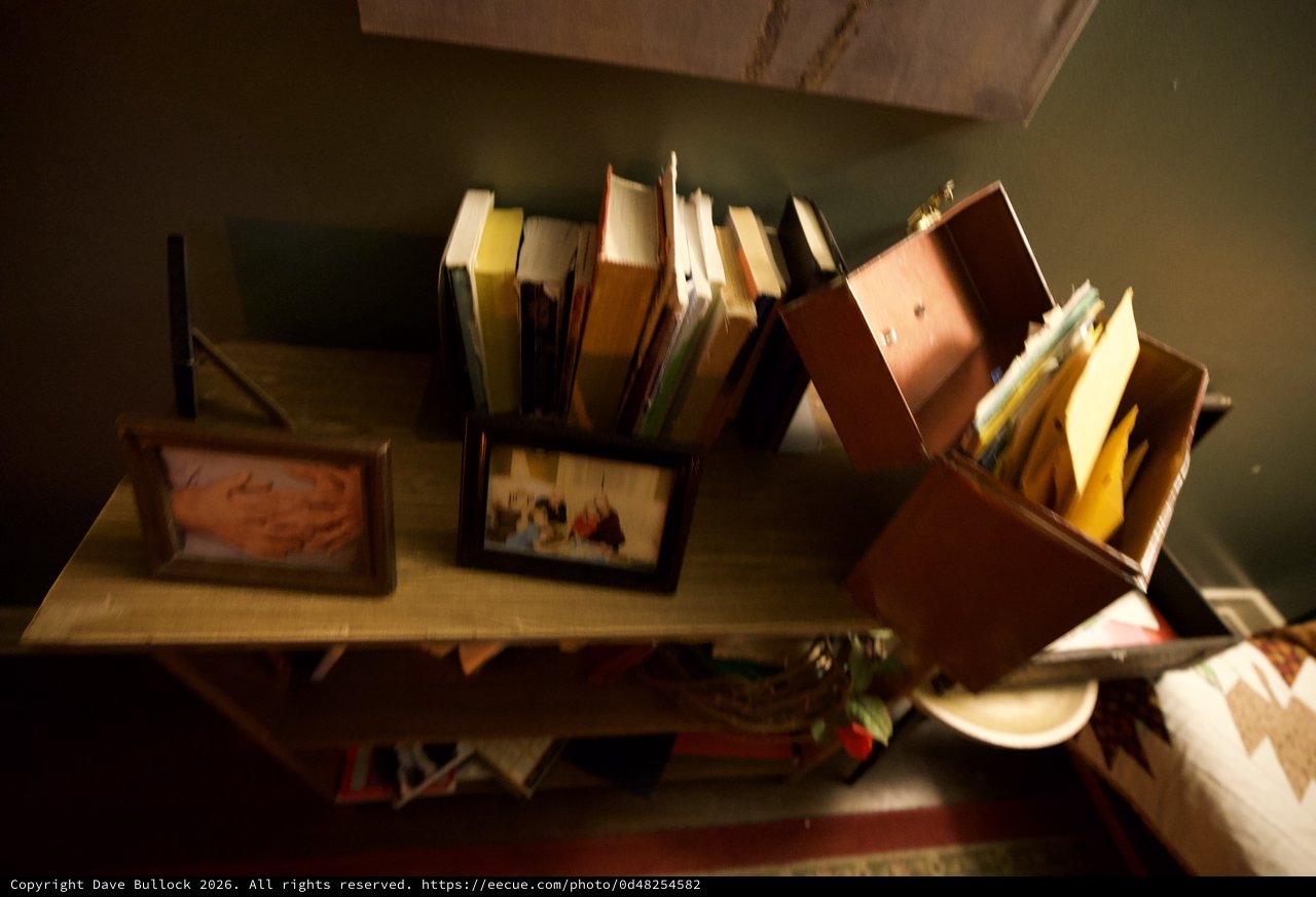 Disorganized Book Collection on Wooden Shelf
