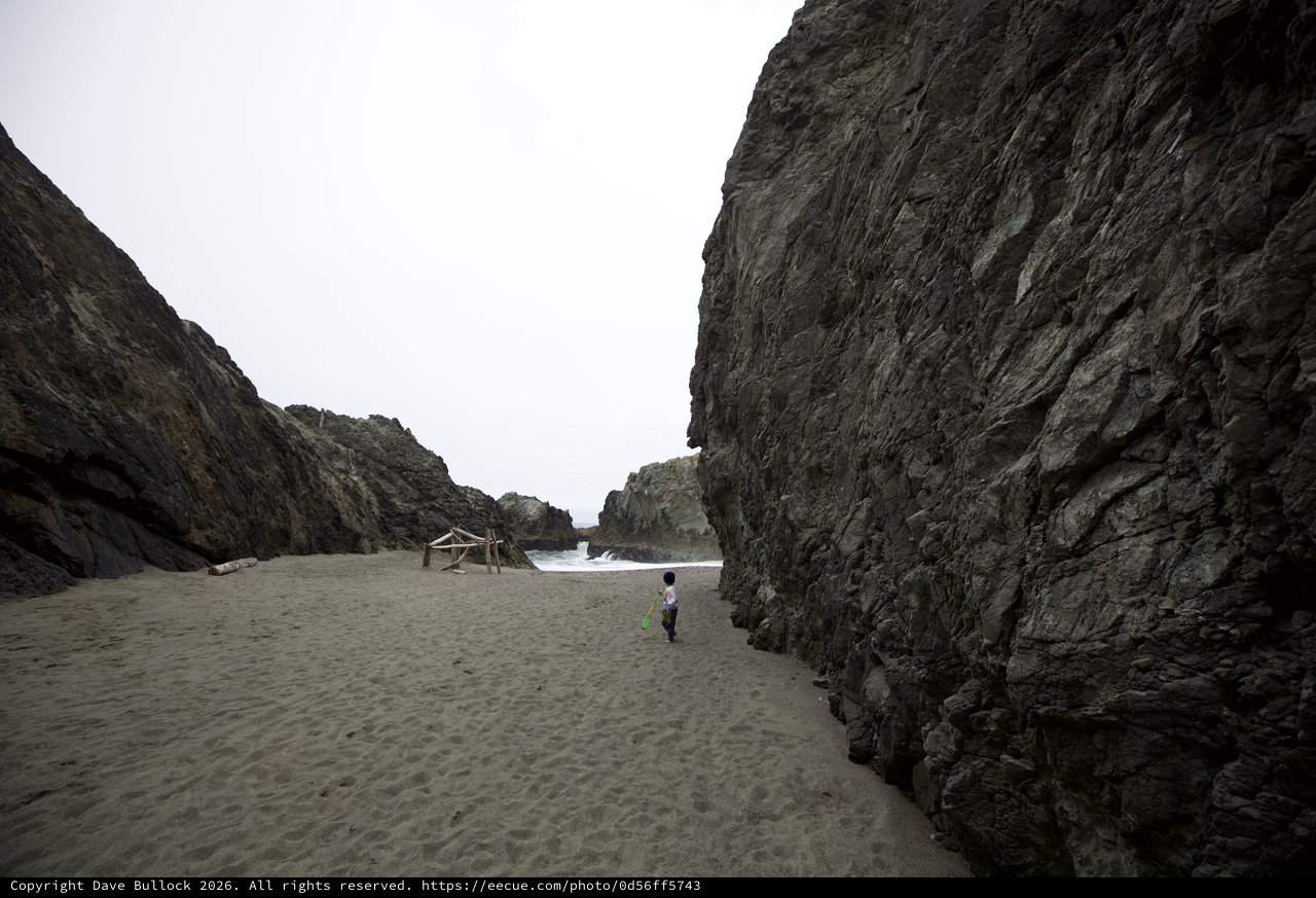 Small Child Explores Dramatic Coastal Rock Canyon
