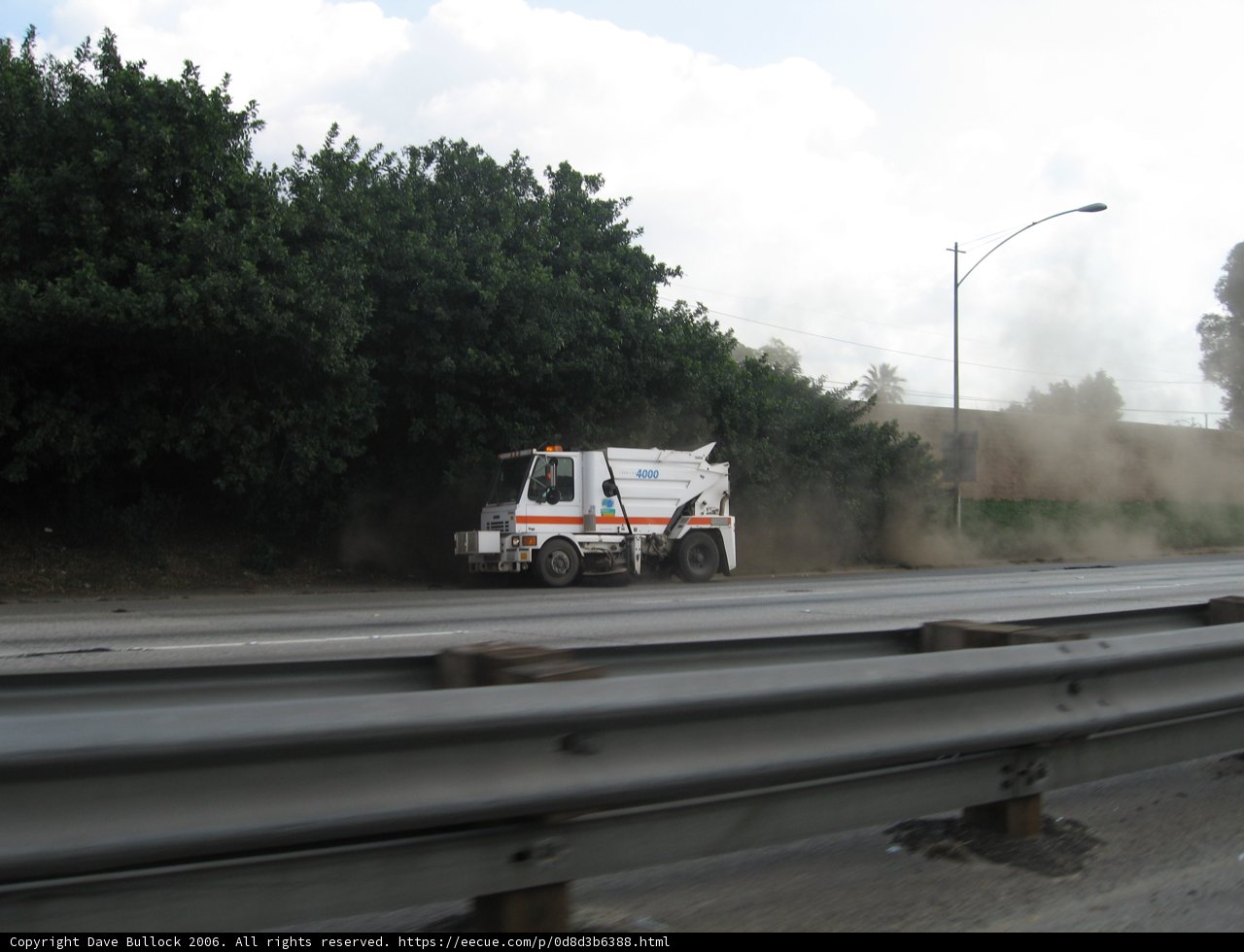 A Truck Making Its Way Down the Dusty Road
