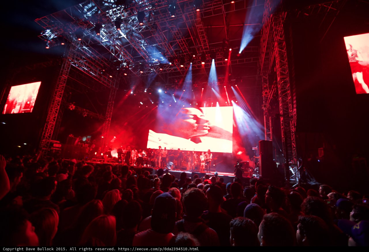 Belle and Sebastian Wide Stage Video Screens Both Sides Romantic Imagery Red Lighting Crowd